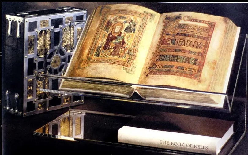 The Book of Kells displayed in a glass case, showcasing its richly illustrated pages with intricate Celtic designs and religious iconography.